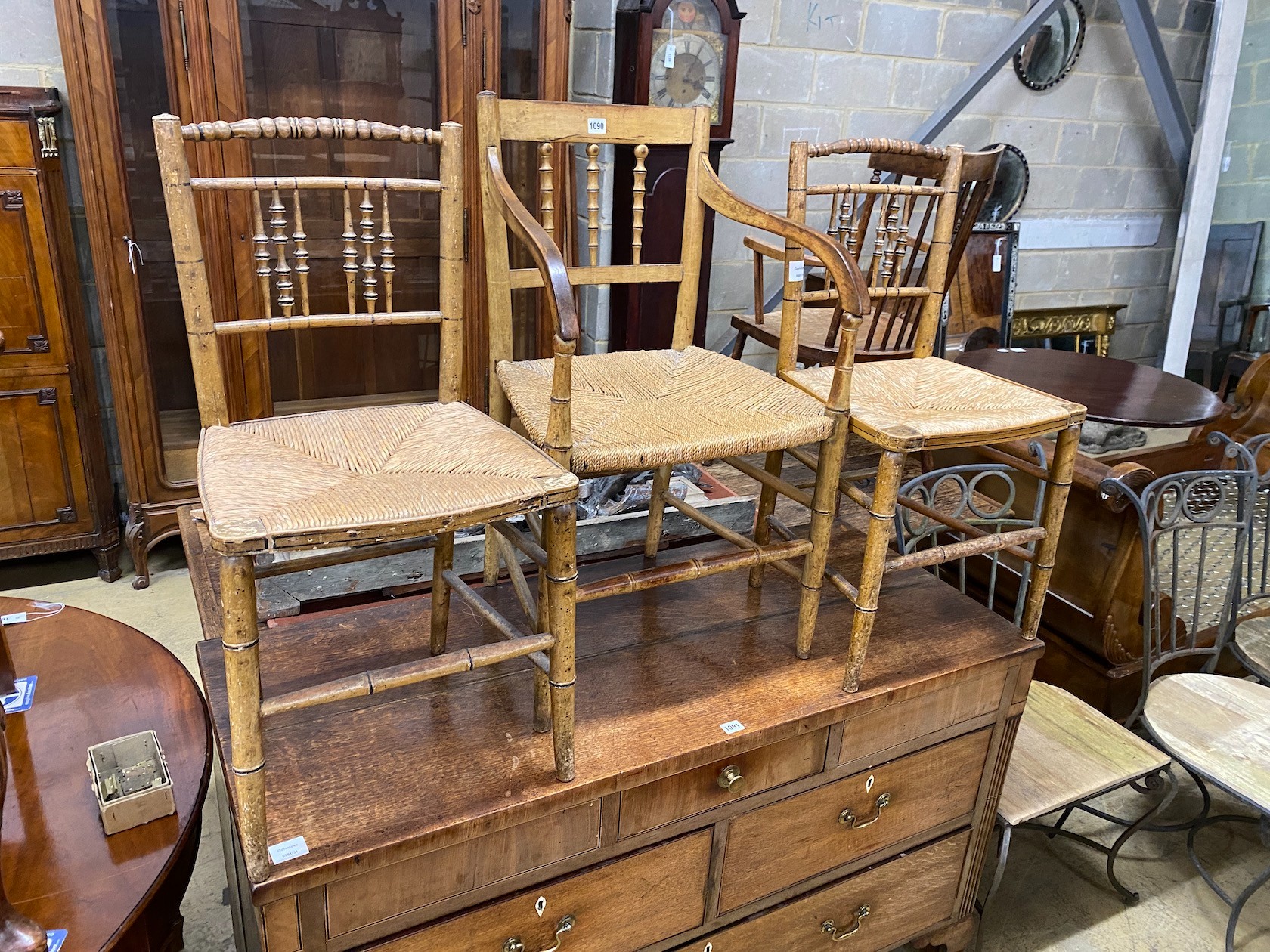 Three Regency painted rush seat chairs, one with arms, largest width 49cm, depth 40cm, height 74cm